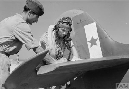 A pilot from the Balkan Air Force (BAF) 352 (Yugoslav) Squadron signs his aircraft serviceability report prior to flight. The BAF was officially created on 7th June 1944. (IWM, London, photographic archive, CNA 3099)