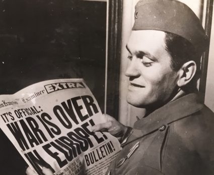 Vladimir Dedijer reads the newspaper headline: ‘The War is Over’. (IWM, London, photographic archive)