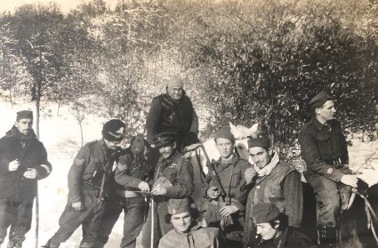 Sergeant McFarlane, Colonel Bailey, and Brigadier Armstrong with their radio operators and JVuO escorts study a map whilst on the move. (Personal photographic collection of Mr. Harry Fenney)